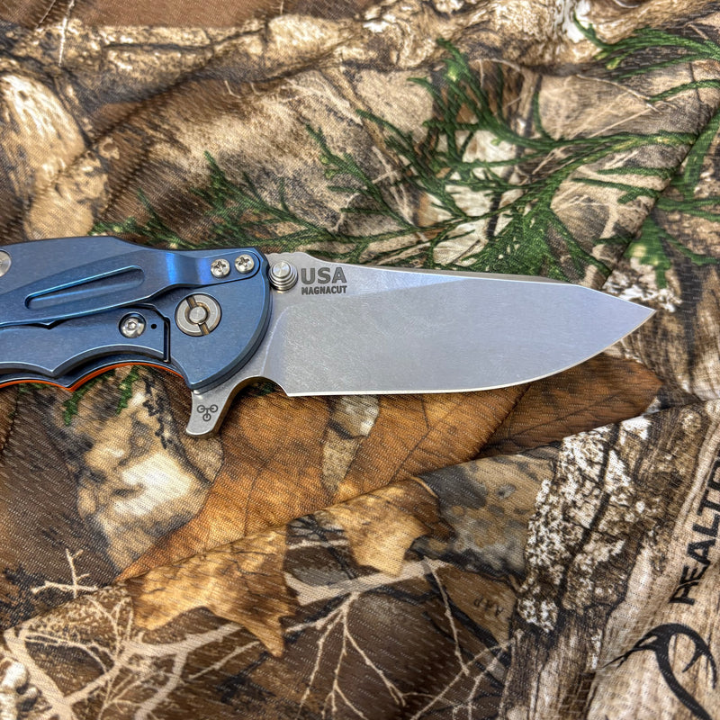 Load image into Gallery viewer, Rick Hinderer Jurassic 3.375" Magnacut Slicer, Hollow Grind, Tri-Way, Stonewash Blue, Orange G10 Knife

