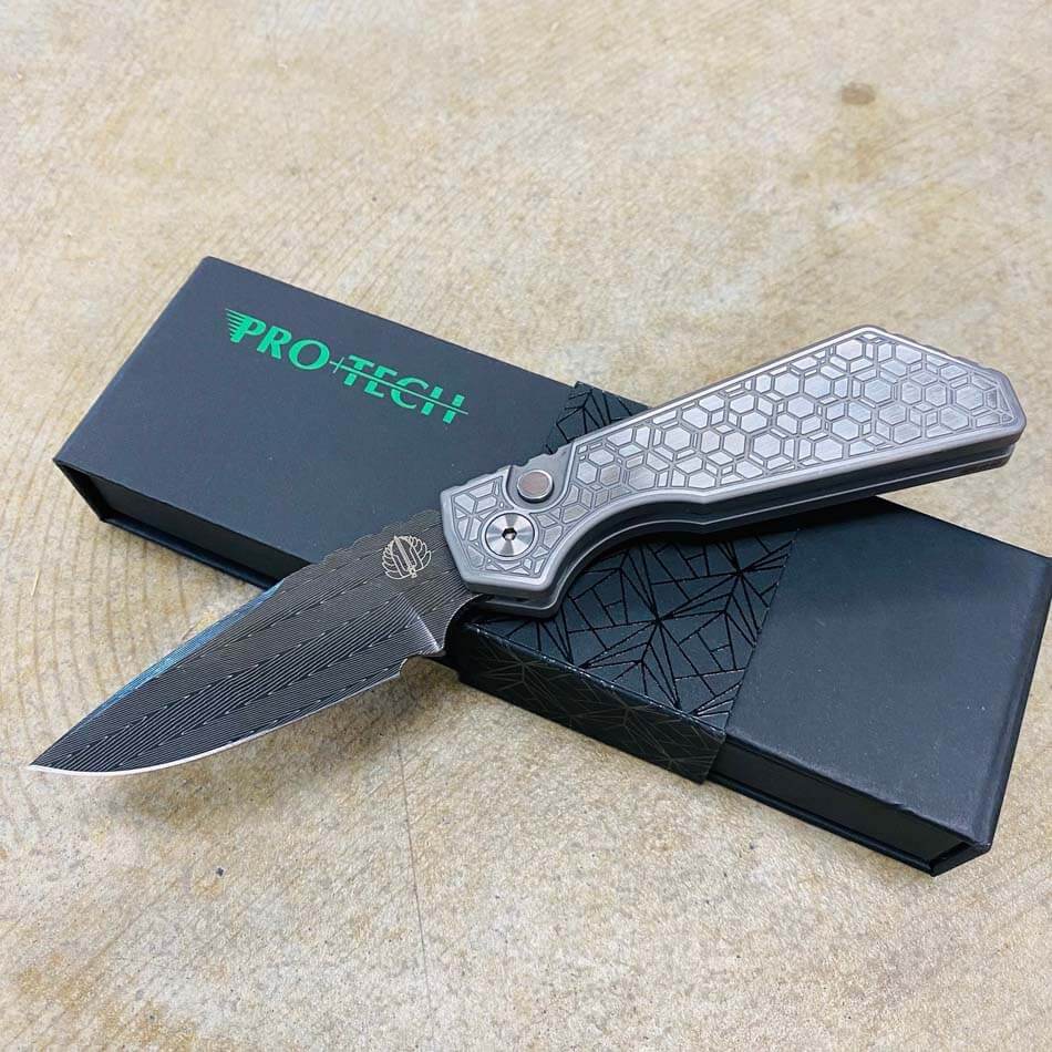 ProTech 2023 Strider PT+ Custom 003 17-4 Stainless Steel with Gridlock Pattern Handles, Satin Hardware, Black Lip Pearl Button, Mike Irie Ground Vegas Forge Herringbone Blade, Automatic Knife BLADE SHOW 2023