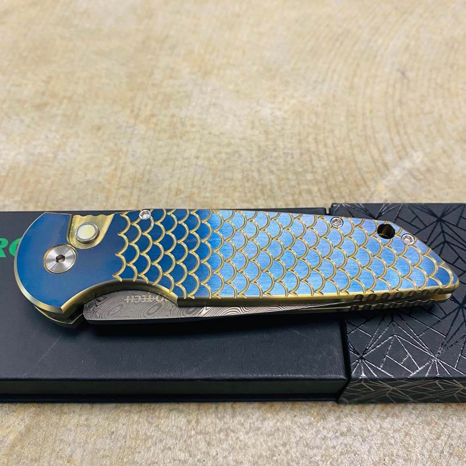 PROTECH 2023 TR-3 Custom 001 Tactical Response 3 Damasteel with Mike Irie Compound Ground Blade, Titanium Fish Scale 2 Tone Bronze Chamfers with Orange Peel Blue Flats, Pearl Button, Automatic Knife - 2023 TR-3 Custom 001